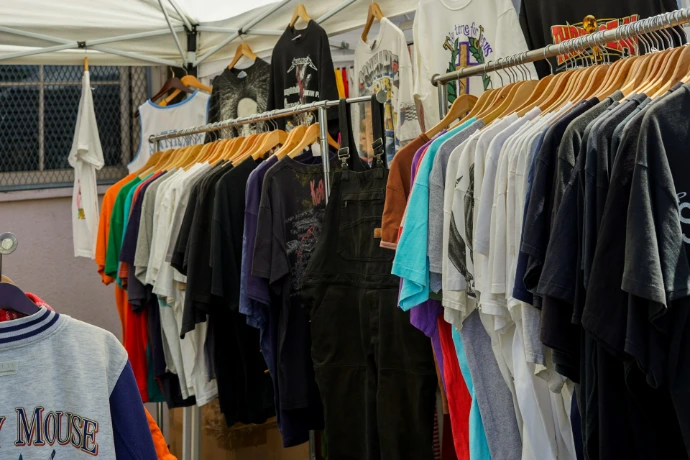 a bunch of shirts hanging on a rack